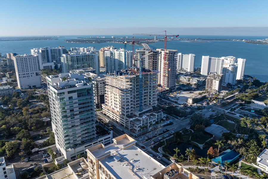 Aerial view of multiple high-rise buildings under construction near waterfront