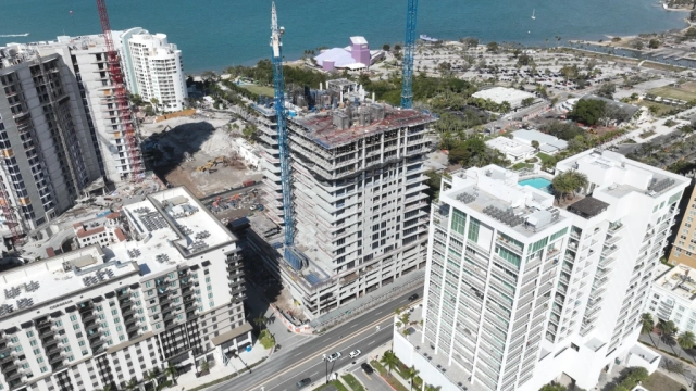 West aerial view of high-rise construction beside Sarasota Bay.