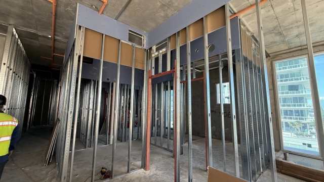 Interior construction with metal stud framing and concrete floors.