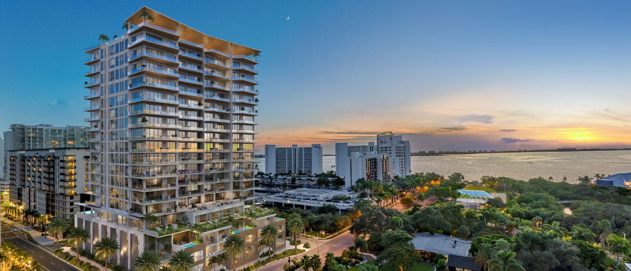 Completed residential high-rise overlooking waterfront at sunset